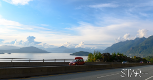 A car on the road with a roof rack on top.